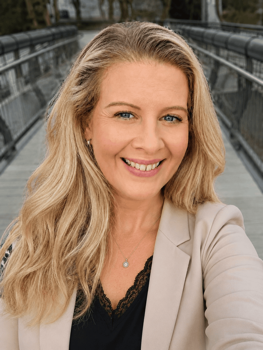 Smiling professional woman in beige blazer | Home Service