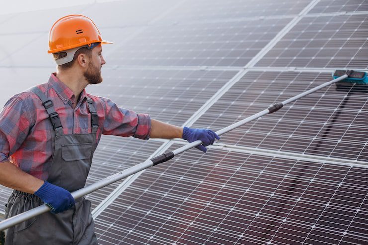 male worker cleaning solar panels | HomeServices